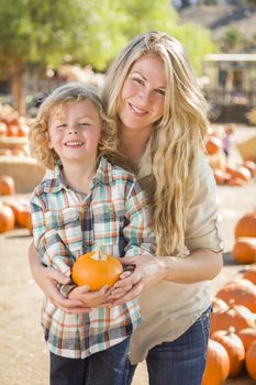 Attractive Mother and Son Portrait in a Rustic Ranch Setting at the Pumpkin Patch.
