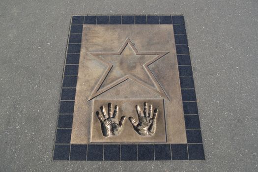 Holywood star plaque with hand prints in the ground
