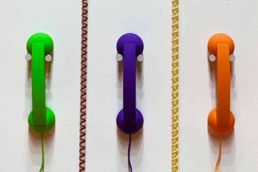 Phones on the wall with phone cords