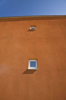 Windows on a terracotta wall
