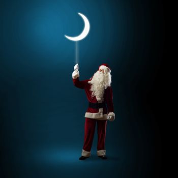 Santa Claus holding a string of luminous glowing moon