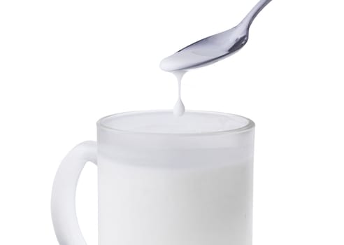 Drop milk from spoon into cup