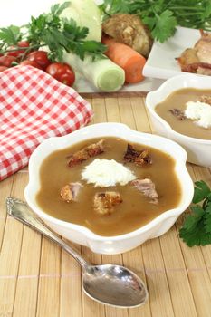 white bowls with duck soup and cream