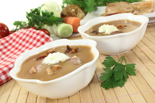 white bowls with duck soup and cream