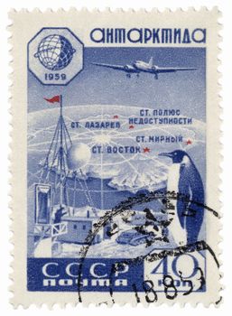 USSR - CIRCA 1959: A stamp printed in the USSR, shows research station in Antarctica, map, plane and penguin, circa 1959