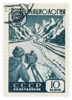 USSR - CIRCA 1959: A stamp printed in the USSR, shows researcher glaciologist takes measurements on a mountain glacier, circa 1959