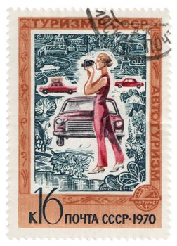 USSR - CIRCA 1970: A stamp printed in the USSR, shows woman with camera and car, series 'Tourism in USSR', circa 1970