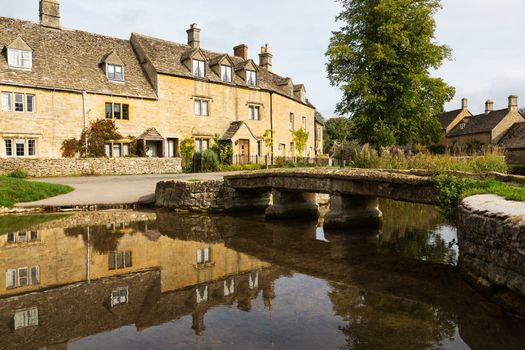 Lower Slaughter with river in Cotswold or Cotswolds district of southern England in the autumn.