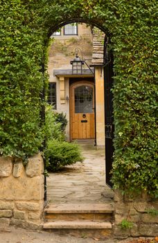 Entrance to front door of cottage in Stanton in Cotswold or Cotswolds district of southern England in the autumn.
