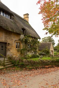 Thatched cottage in Stanton in Cotswold or Cotswolds district of southern England in the autumn.