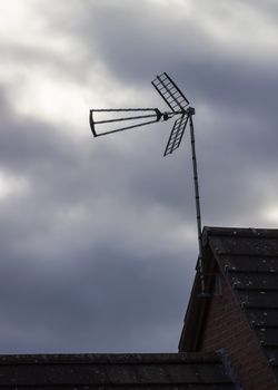 British TV aerial on mast on cloudy stormy day