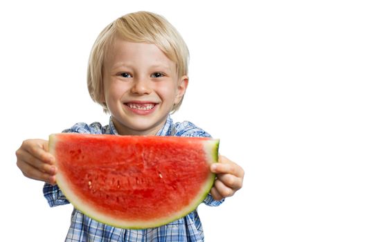 A smiling boy holding out a big juicy slice of watermelon. Isolated on white.