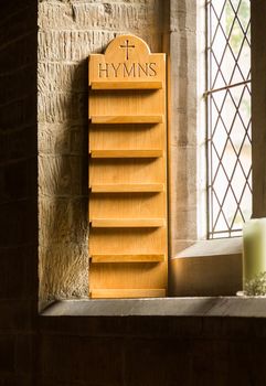 Empty hymn stand in window of old parish church in Cotswold or Cotswolds district of southern England