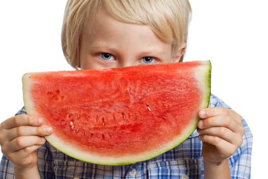 A cute happy smiling boy holding a big juicy slice of watermelon. Isolated on white.