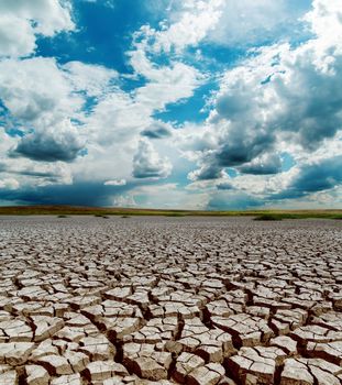 global warming. dramatic sky over cracked earth