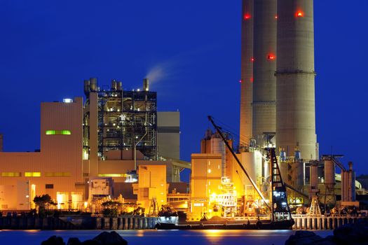 power station at night with smoke 