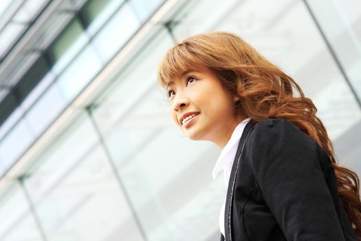 young business woman and an office background