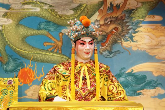 chinese opera dummy and red cloth as text space ,it is a toy,not real man 