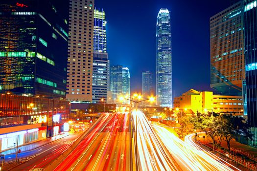 Colorful city night with lights of cars motion blurred in hong kong