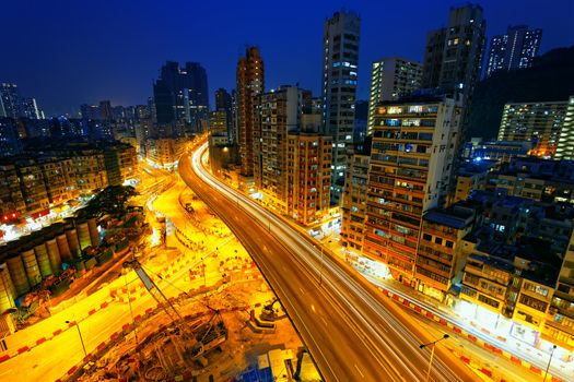 Colorful city night with lights of cars motion blurred in hong kong 