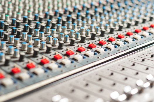 Closeup shot of audio mixer in recording studio