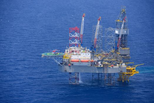 Top view of helicopter pick up passenger on the offshore oil rig.