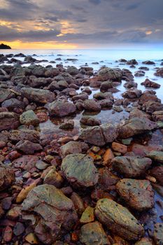 beautiful seascape of wave and rock and the sunset