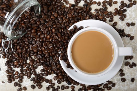 top view of hot coffee cup and beans