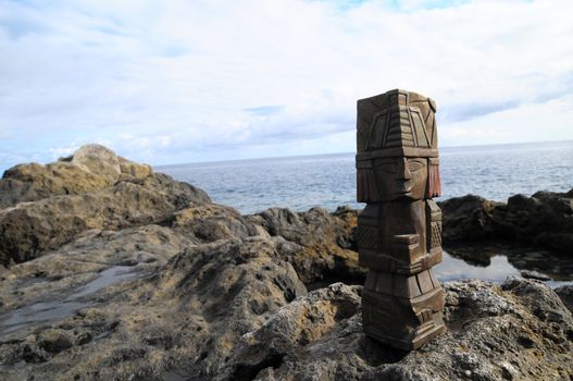 Ancient Maya Statue on the Rocks near the Ocean