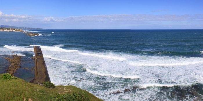 panorama of a coastal town by the sea with its beach and mountains