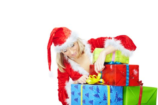 Lady in the red Santa costume opening colofrul boxes with Christmas gifts