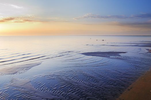 Photo of the sea coastline during sunrise in summer