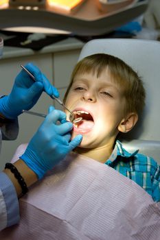 Shot of a little boy with a doctor in a dental surgery. Healthcare, medicine.