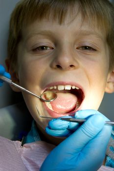 Shot of a little boy with a doctor in a dental surgery. Healthcare, medicine.