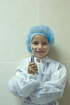 child playing in doctor dentist. Choosing a profession