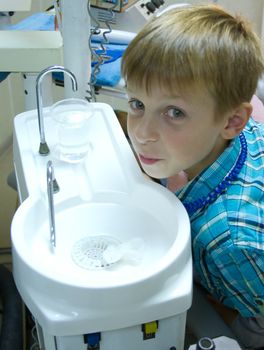 At the dentist dental patient  spit water after treatment