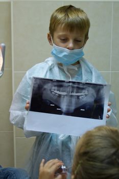 child plays in a dentist. Choosing a profession