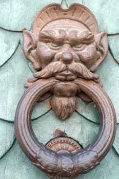Vintage rounded knocker door of metal face