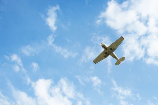 Airplane flys in the cloudy sky. Natural light and colors
