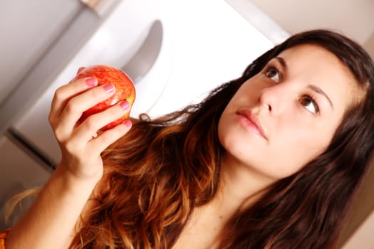 A young adult woman holding a Apple.