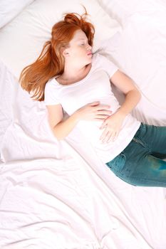 A young adult Woman sleeping on bed.
