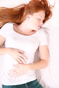 A young adult Woman sleeping on bed.