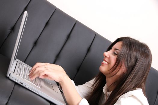 A young woman surfing on the Internet with a Laptop.  
