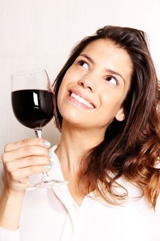 Portrait of a beautiful, latin Woman drinking red wine.