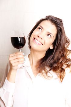 Portrait of a beautiful, latin Woman drinking red wine.