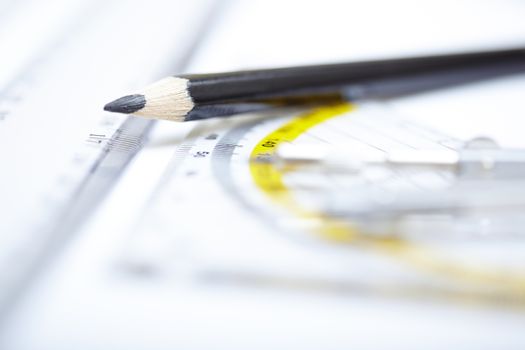 Drawing tools on a paper. Extremely close-up photo with shallow depth of field. Focus on pencil