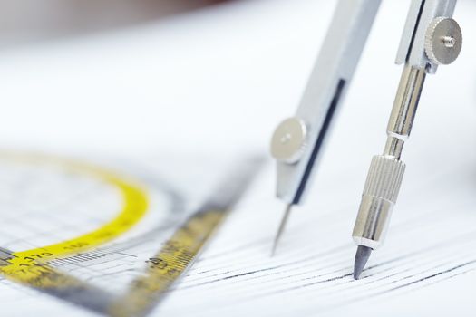 Compasses and ruler on a graphic. Extremely close-up photo