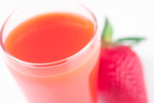 strawberry and a glass of strawberry juice isolated on white