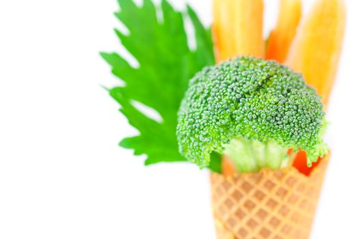 carrot, celery, broccoli in a waffle cone isolated on white