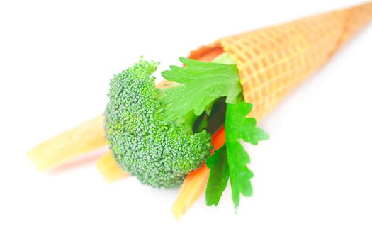 carrot, celery, broccoli in a waffle cone isolated on white